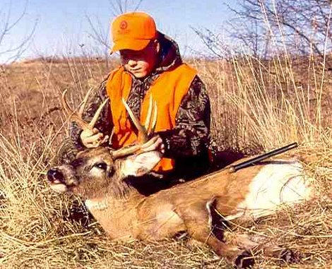 A young hunter admires his harvest